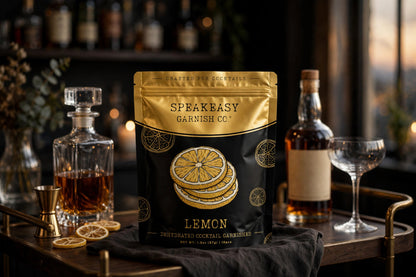 Speakeasy Garnishes lemon pouch on a home bar cart among bottles and glassware